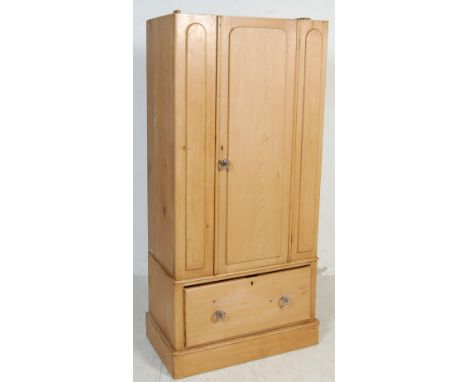 A late 19th century Victorian pine single wardrobe. The pedestal wardrobe having a single panel four above a single large dra