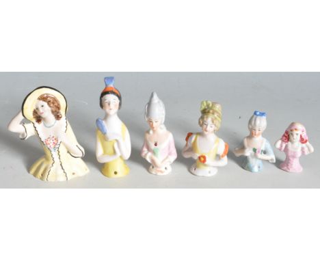 A collection of early 20th century ceramic porcelain pin cushion half dolls comprising of an Art Deco 1930s flapper girl, a G