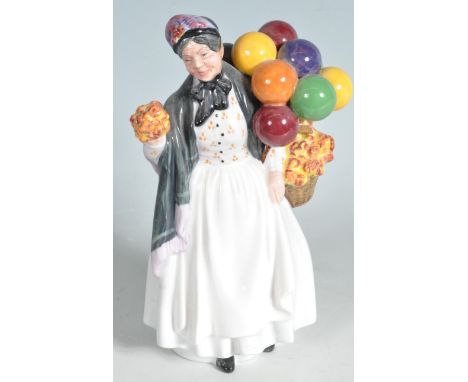 A Royal Doulton figure Biddy Penny farthing HN 1843. The ceramic figurine depicting a lady with a basket of flowers and ballo