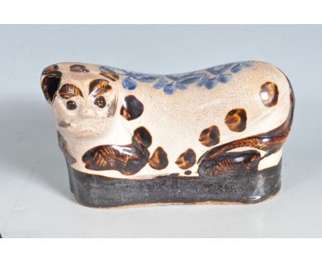 A Chinese oriental ceramic cizhou style pillow in a form of a cat. The cream glazed pottery is stylistically modelled as a re