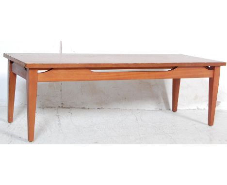 A retro vintage late 20th century teak wood long john coffee table of rectangular form raised on square tapering legs. Measur