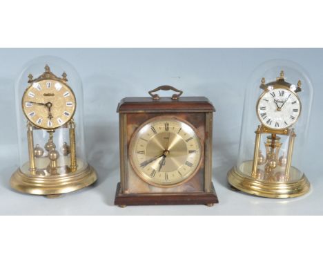 A collection of vintage 20th century clocks comprising of a Hermle anniversary clock set within a glass dome, Kundo anniversa