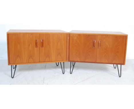 A pair of vintage 1970’s teak wood G Plan Fresco range sideboard cabinets having twin doors cupboard with shaped handles rais