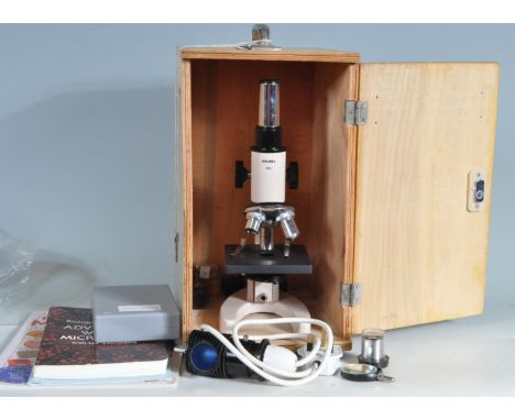 A vintage Brunel RM-1 microscope complete with various lenses and accessories, slides, instruction manual etc. Set within fit
