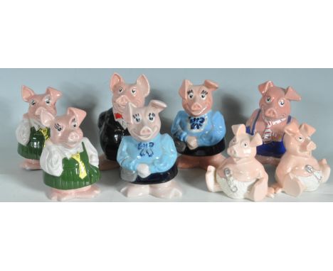 A collection of eight vintage late 20th century ceramic Wade Nat West Pigs having polychrome decoration with black stopper to