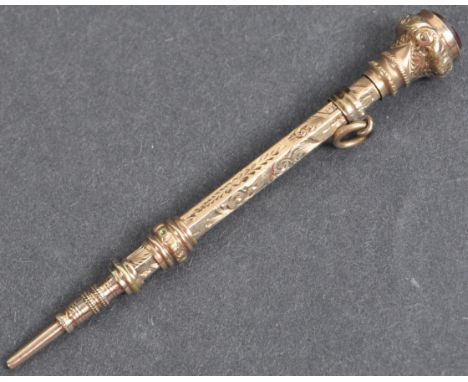 A 19th Century Victorian 9ct gold mechanical pencil being set with a round red stone panel to the top with engraved foliate d