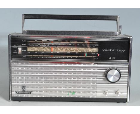 A retro vintage 20th century Grundig Yachtboy portable transistor radio having LW/MW/SW/FM frequencies and carry handle to th
