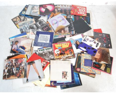 A large collection of vintage vinyl LP records comprising of Genesis, Barry White, Mamas and the Papas, The Scorpions, Sade, 