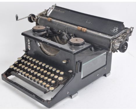 A vintage 20th Century Imperial typewriter having four rows of rounded buttons, a black painted body with twin ribbon spools 