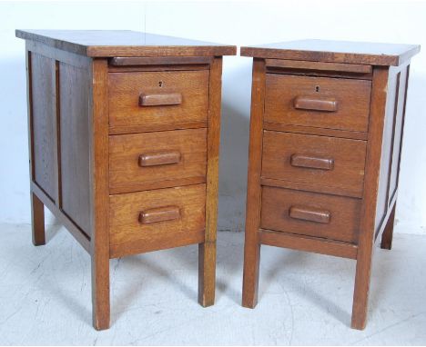 A pair of retro vintage mid 20th century oak bedside cabinets / office cabinets having pullout slides over a bank of three dr