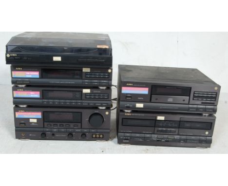 A retro vintage late 20th century Aiwa audio hi fi stacking system composing of a PX-E80 turntable, stereo synthesizer TXZ95,