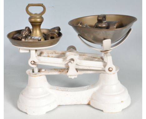 Set of early 20th Century Librasco balance scales, having a painted white cast iron body and brass bowls. Complete with brass