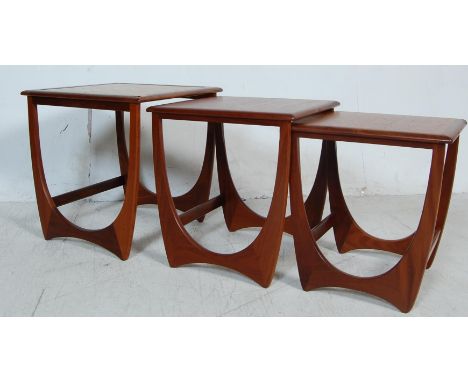 A retro vintage G Plan nest of graduating tables having a tile top with chamfered edges raised on quadrille style supports un