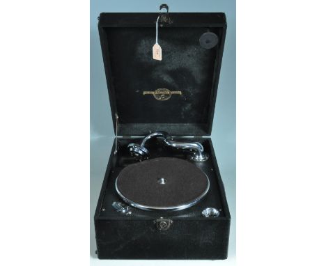 A vintage 20th century portable record player gramophone by Columbia having hinged lid with fitted interior. Along with a qua