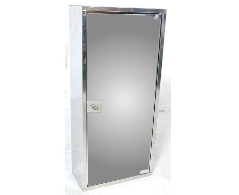 A vintage late 20th Century upright wall hanging / free standing medicine bathroom cabinet of polished metal construction. Fu