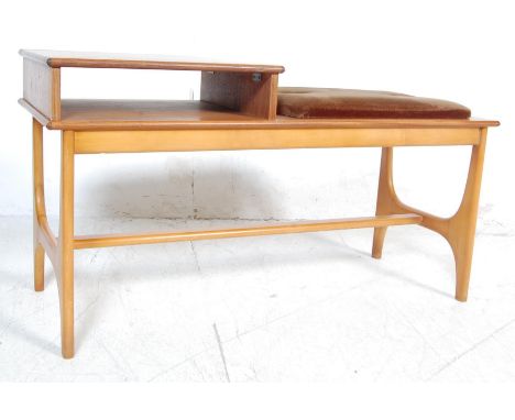 A retro vintage 20th century circa 1980’s teak wood telephone table in the manner of G Plan. The seat table of a rectangular 