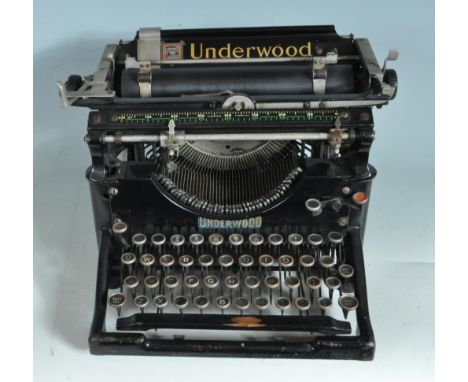 A vintage 20th century Underwood typewriter having a ebonised metal frame with gilt detailing. Comes with soft case. Measures