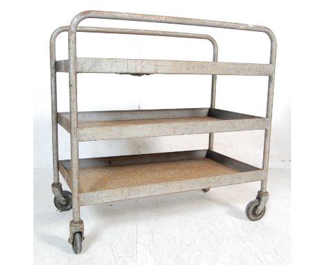 A vintage retro mid 20th century metal factory industrial trolley / kitchen trolley. The two tier trolley having curved handl
