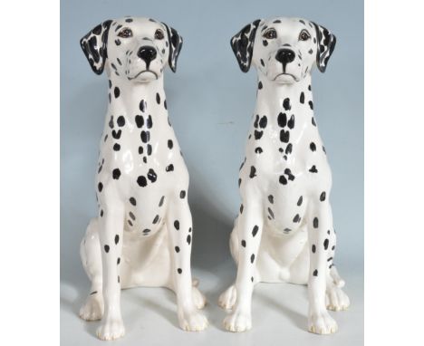 A pair of Beswick ceramic dalmatian dog figurines each having hand painted details. Marked Beswick 2271 to the bases. AF repa