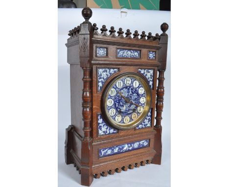 An antique Edwardian bracket clock having a blue and white ceramic face with Arabic numerals to the chapter ring. The clock h