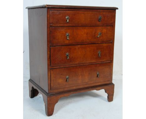 An antique George III mahogany bachelor's chest of drawers having a flared top over a bank of four drawers with brass drop ha