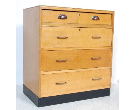 A retro vintage mid 20th century Air Ministry style chest of drawers having a flip down / plan drawing top drawer and three d