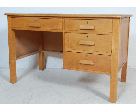 A vintage retro 20th century light oak Air Ministry type office desk. The desk of a rectangular form with single drawer to th