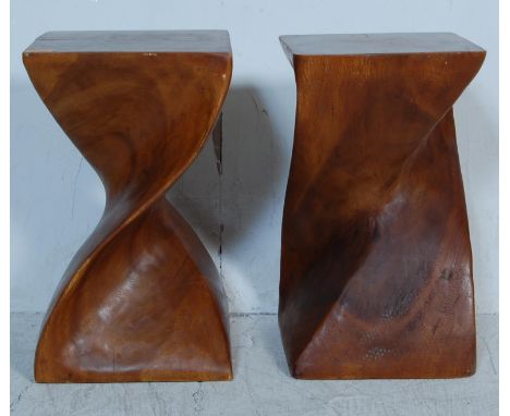 A pair of vintage 20th century exotic hardwood side tables / display stands of cuboid form with a helix swirl column. Carved 