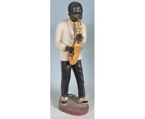 A large pair of vintage retro 20th century ceramic Jazz band players. A large saxophone player and a drum player. Both having