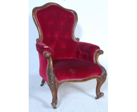A Victorian 19th century show wood mahogany armchair. Raised on scrolled legs with hoof feet having a good overstuffed uphols