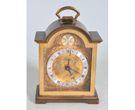 A 20th century brass miniature mantel clock / carriage clock. The 8 days alarm clock by Swiza having brass face with Roman nu