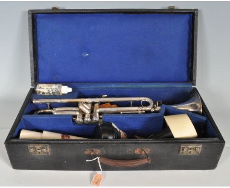 A vintage retro 20th century Broadway trumpet. The trumpet having three mother of pearl keys, circular tapered sound horn (11