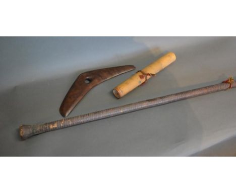 A Tribal Boomerang Together With A Blow Pipe With Darts 