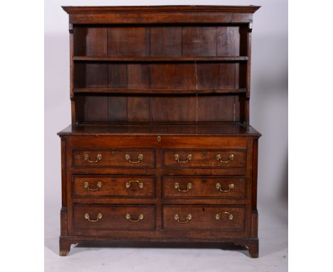 George III oak mule chest, hinged lid with two dummy drawers over four drawers, adapted as a dresser with a two-shelf rack, w