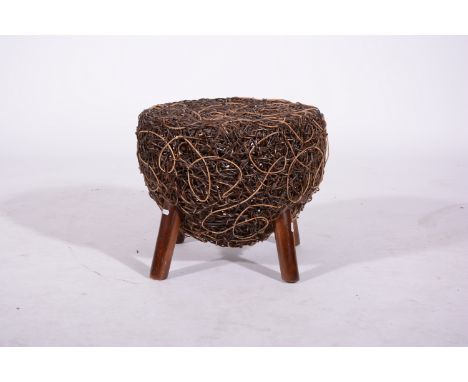 A vintage cane stool, randomly woven in two colour cane on four tapered wooden legs, seat 52cm diameter, 44cm high. 