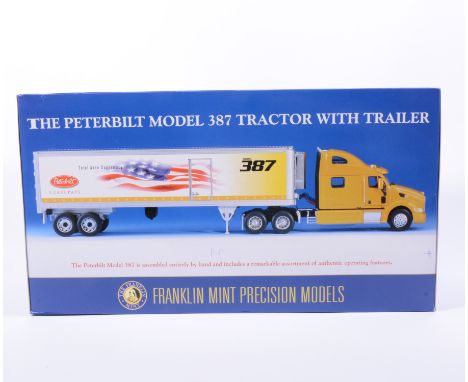 Franklin Mint precision model; The Peterbilt model 387 tractor with trailer 1:32 scale, boxed. 