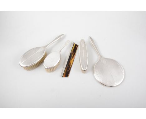 Four-piece silver-backed dressing table set, Birmingham 1960, engine-turned, comprising a hand mirror, 56cm; clothes brush; h