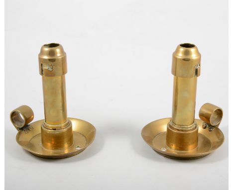 Of military interest; a  pair of brass chambersticks said to be modelled from cannon shells from a WW2 Mosquito fighter plane