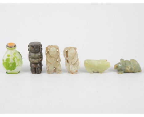 Two carved jade weights, three small figures, and a snuff bottle.
