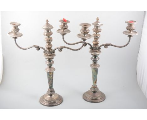 Pair of electroplated three-light candelabra, with twin branches, gadrooned outlines, circular bases, 51cm.