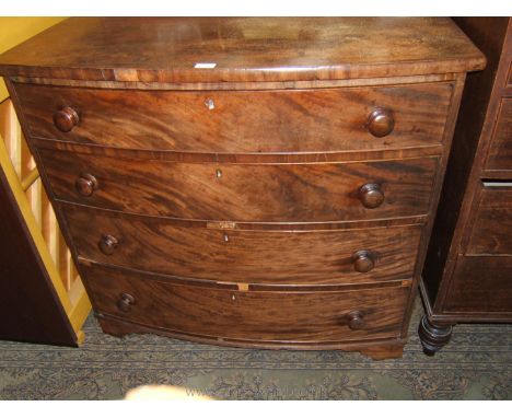 A mid 19th c. Mahogany bow fronted Chest of four graduated drawers, having plain top over the four cock beaded Mahogany and P