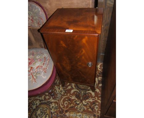 A reproduction Mahogany finished Georgian style Pot Cupboard, having moulded top, half veneered single door with brass ring h