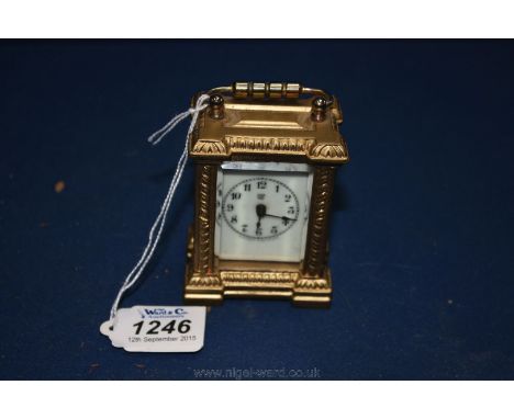 A small wind up American Carriage Clock by ''Waterbury Clock Co''. with enamelled face and bevel glass 3'' tall.
