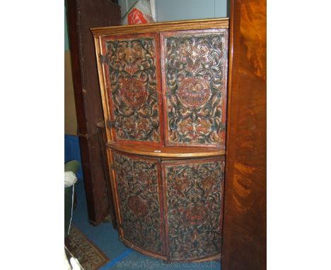 A Spanish floor standing Corner Cabinet, having moulded cornice over pair of opposing doors, opening to reveal a single shelf