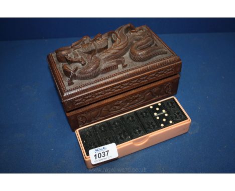 A carved wooden Trinket Box with dragon detail to the top and surround and a boxed set of Dominoes.