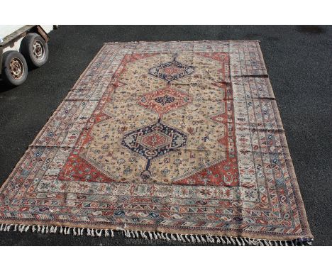 A Caucasian madder ground Carpet with multiple borders. 13ft 9in x 9ft 10in (420cm x 300cm)