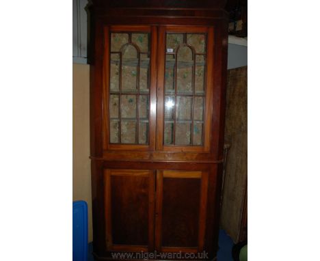 A good 19th c. flame Mahogany floor standing two tier Corner Cabinet, having moulded cornice over pair of opposing eight pane