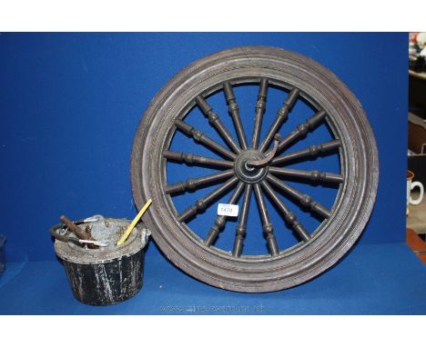 A nicely crafted Treen wheel from a spinning wheel, having bobbin turned spokes, 18 1/4'' diameter and with wrought iron fitt