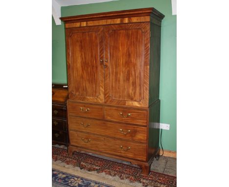A Georgian Mahogany Linen Press having moulded cornice over pair of opposing single panel diagonally cross-banded doors with 
