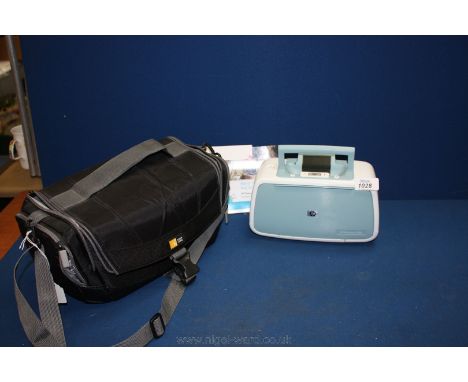 A portable H.P Photosmart A526 compact Digital Printer with plug,paper and instruction booklets all in a case logic carry bag